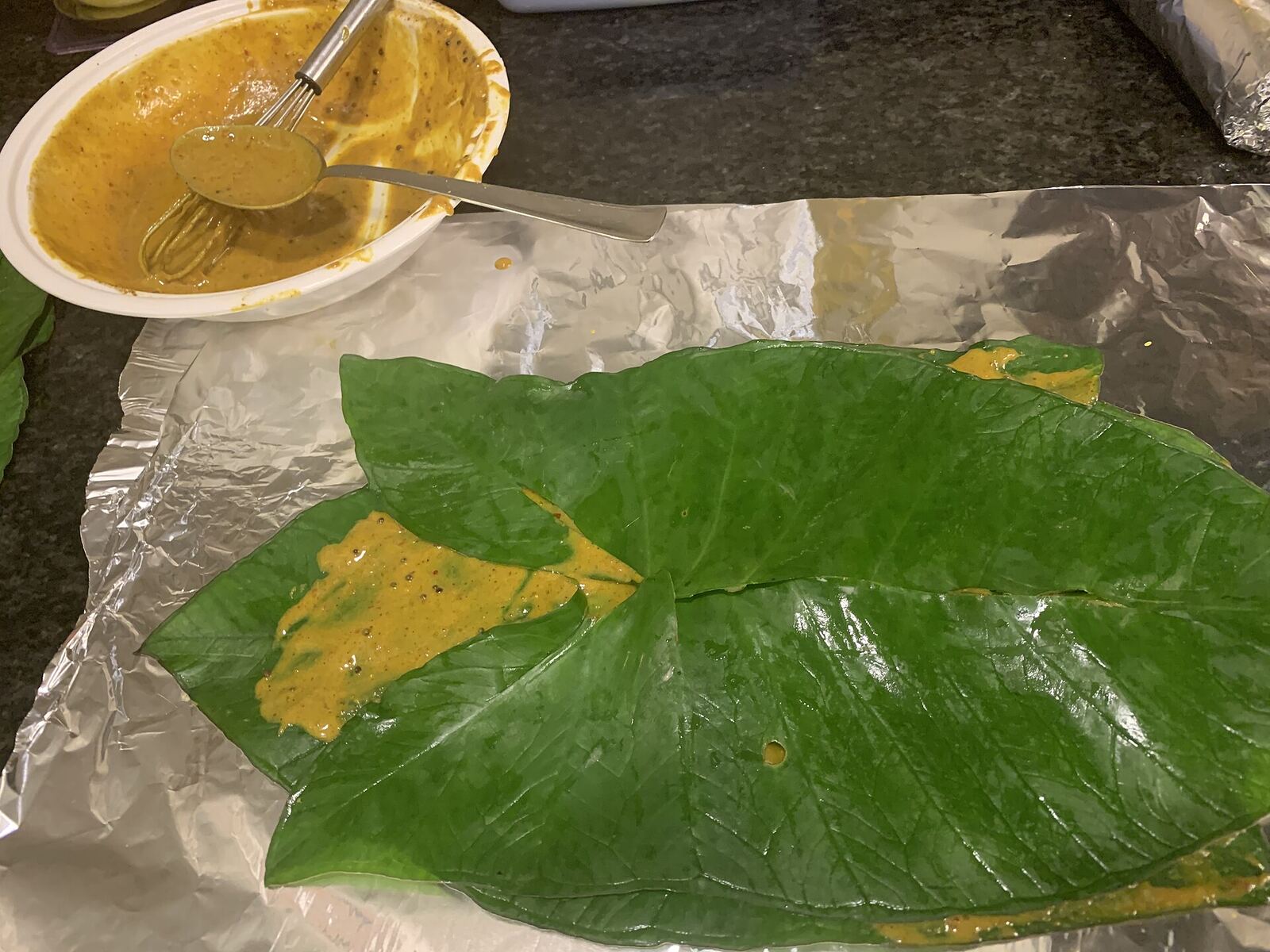 Patrel1 – Fresh Colocasia leaves stacked with gram flour paste between the layers. Picture taken in the kitchen.